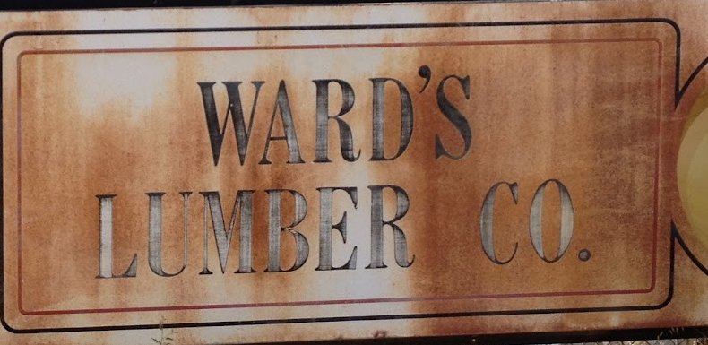 The original rusted Ward's Lumber Co. sign, still hanging on the yard fence